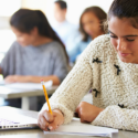 student writing on paper